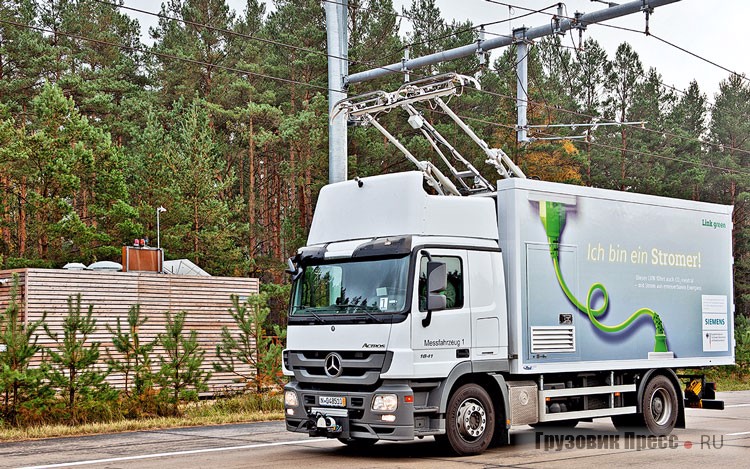 Грузовик проекта ENUBA 1 на шасси Mercedes-Benz Actros 1841 MP3, построенный в 2012 году. На заднем плане видна тяговая подстанция сети