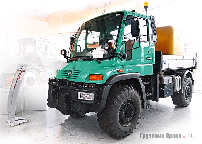 [b]Unimog U405.102.[/b] 2000 г. Новое поколение Unimog U400 с кабиной из углепластика, равно как U300 и U500 полной массой 10–16 т, серийно производят на заводе DaimlerChrysler AG (ныне Daimler AG) в г. Вёрте с апреля 2000 года. Стандартные цвета – оранжевый, красный, белый. На выбор предлагаются четыре двигателя: два 4-цилиндровых, уровня Euro 3, мощностью 130 кВт/177 л.с. для U300/U400 и 170 кВт/231 л.с. для U500, один 6-цилиндровый, уровня Euro 4, с отдачей в 130 кВт/177 л.с. для U300/U400 и один 6-цилиндровый, Euro 4, с потенциалом в 210 кВт/286 л.с. для U500. Колесная база – 3080 или 3300 мм, резина – 365/80 R20 на дисках 11x20 или 445/70 R24 на дисках 13x24. Рабочее место водителя VarioPilot для лучшей уборки тротуаров позволяет переставлять щиток приборов и педальный узел с левой стороны на правую и наоборот.